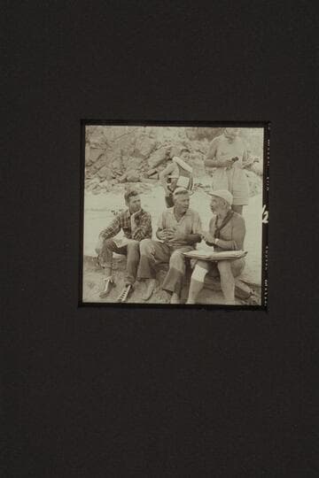 Briefing the course from Diamond Creek to the head of Lake Mead, Mile 235.  Diamond Creek Camp.  Left to right (seated):  Hugh Cutler; Rod Sanderson; and Marston.  Above are Buzzy Belknap and a portion of Masland